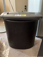 Side view of black basket with white stitching