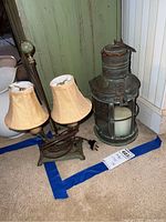 Antique copper lantern and vintage double-shaded metal table lamp together, showing overall size, shape, and condition
