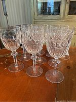 Front view of all 12 glasses on wooden table