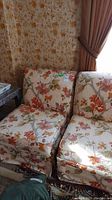 Two armless floral patterned chairs wide view
