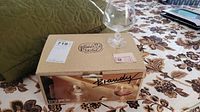 Set of six Bohemian crystal brandy glasses in original vintage box labeled 'Brandy', showing box details and one glass on top.