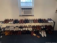 Two-tier shoe rack with various men's dress shoes and sneakers in multiple colors including brown, black, and white. Left to right view showing 36 pairs in total size 9 and mostly wide width.
