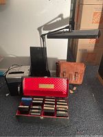 All items together showing leather satchel, task lamp, shredder, and 8-track tape box