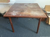 Top view of folded table surface showing scratches and dust