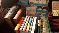Photo showing a variety of Christian books including older large hardcover volumes like Young's Analytical Concordance, children's storybooks and other titles related to Bible and Christmas.