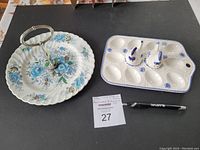 Photo showing the ceramic serving tray with handle and the ceramic egg dish with chicken-shaped salt and pepper shakers on it.