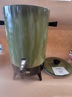 Green Empire coffee maker with black handles and a spout, sitting next to the removed lid.