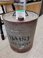 Full side view of the vintage Daisy Oil Can showing branding and condition.