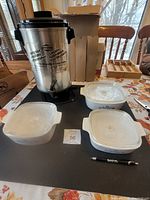 West Bend coffee pot with three Pyrex cooking dishes with lids and pen for scale