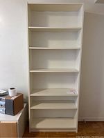 Front view of the white IKEA Billy bookcase with six shelves in light used condition.