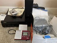 Lot contents with Yamaha DVD player, Pentax camera with manuals, IDE Works radio, Garmin GPS in bag