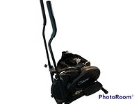 Photo of Orbitrek fitness walking simulator showing entire unit from an angle with black handles and pedals.