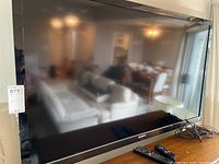 Frontal view of the Sony flat screen TV with reflections of the room visible on the screen.