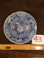 Blue Room Spode plate showing botanical pattern and scalloped edge, placed next to a 12-inch ruler showing it measures about 11 inches in diameter