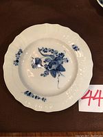Full view of the Royal Copenhagen collector plate with visible blue floral design and scalloped edges.