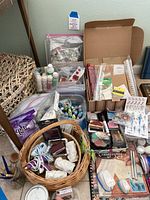 Overview showing basket, paints, ink pads, stamps, ribbons, and crafting materials