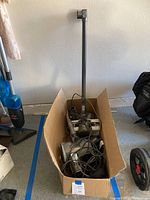 Shark Rocket vacuum cleaner parts and accessories packed inside a cardboard box with cords and detachable parts visible.