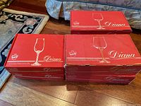Stack of red Diana series Bohemia Crystal glassware boxes showing variety and quantity.