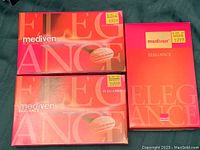 Three boxes of Mediven Elegance compression stockings in shades caramel, beige, and black, showing front and packaging design.