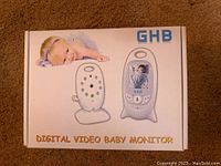 Box front showing GHB brand and digital video baby monitor units with a baby image.