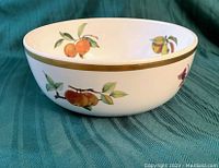 Royal Worcester Evesham fruit bowl angled view showing orange, apple, and pear fruit motifs with gold rim
