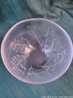 Top view showing circular bowl opening and embossed leaf motifs inside.