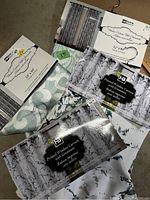Curtain panels in packaging showing multiple colors and patterns, and brand Homeberg