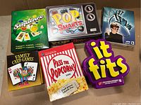 Top view showing all six board game boxes fully boxed and visible titles