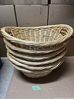 Stacked view of six wicker baskets showing uniform size and good condition with no damage.
