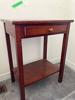 Front and side view of the night table showing the wood finish, drawer, and lower shelf.