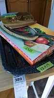 Roasting pan, skillet box with trivets on top, showing size labels (12x19, 10x7) and colorful trivet graphic.