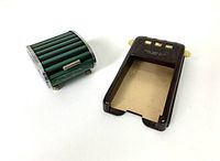 Shows the perpetual calendar and chrome-green ribbed box together from an angled top view.