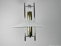 Full frontal view of Robert Sonneman light fixture showing chrome frame and brass central cylinder with white enameled steel shade.