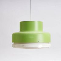 Full side view of green metal pendant light showing shape and suspension cable.