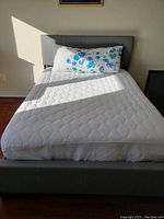 Assembled bed with mattress showing headboard and footboard