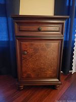 Front view of the hallway table showing drawer and cabinet door with round metal knobs and wood detailing.