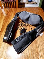 Photo of whole massager showing neck and shoulder padded areas and remote control attached.