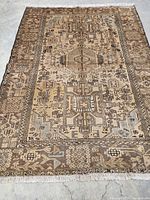 Full top-down view of entire rug on concrete floor