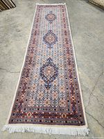 Full view of entire runner laid flat on concrete floor