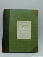 Front cover of The Book of Me hardcover book showing green cover with darker green spine and corners, centered title label.