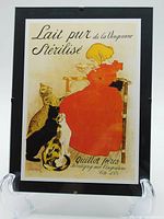 Framed reproduction print featuring a young girl in a red dress drinking milk with three cats looking on, showing full image and frame.