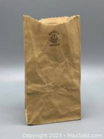 Front view of brown paper bag shaped ceramic vase showing Harvey Craft stamped marking.