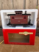 Front view of the Pennsylvania model train car housed in white foam insert and red Bachmann Big Haulers box.