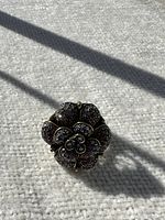 Top view showing flower design and rhinestone detailing.