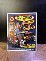 Front view of the colorful vintage Quickies Pump and Polish tin sign with retro car and woman illustration.