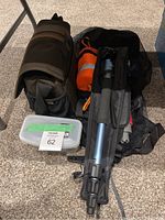 Full lot showing snorkeling gear, floating device, Fotopro monopod in case, and camera bag