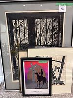 Four framed artworks arranged with the largest piece in the back and the smallest in the front showing general lot condition and sizes
