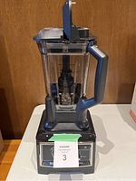Ninja Ultima Blender assembled with pitcher and lid on base placed on table.