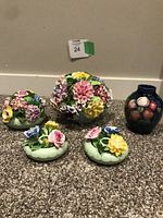 Group photo showing two Adderley floral bone china ornaments, two Adderley floral candle holders, and one small Moorcroft vase.