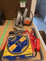 Photo showing the Black & Decker circular saw along with the extra saw blade and hand tools on display.